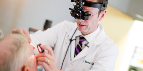Macular degeneration specialist examining patient's eyes for amd symptoms.